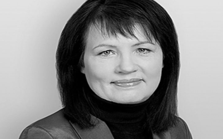 Black and white photo of Manuela Kasper-Claridge in a full neck dress and coat.